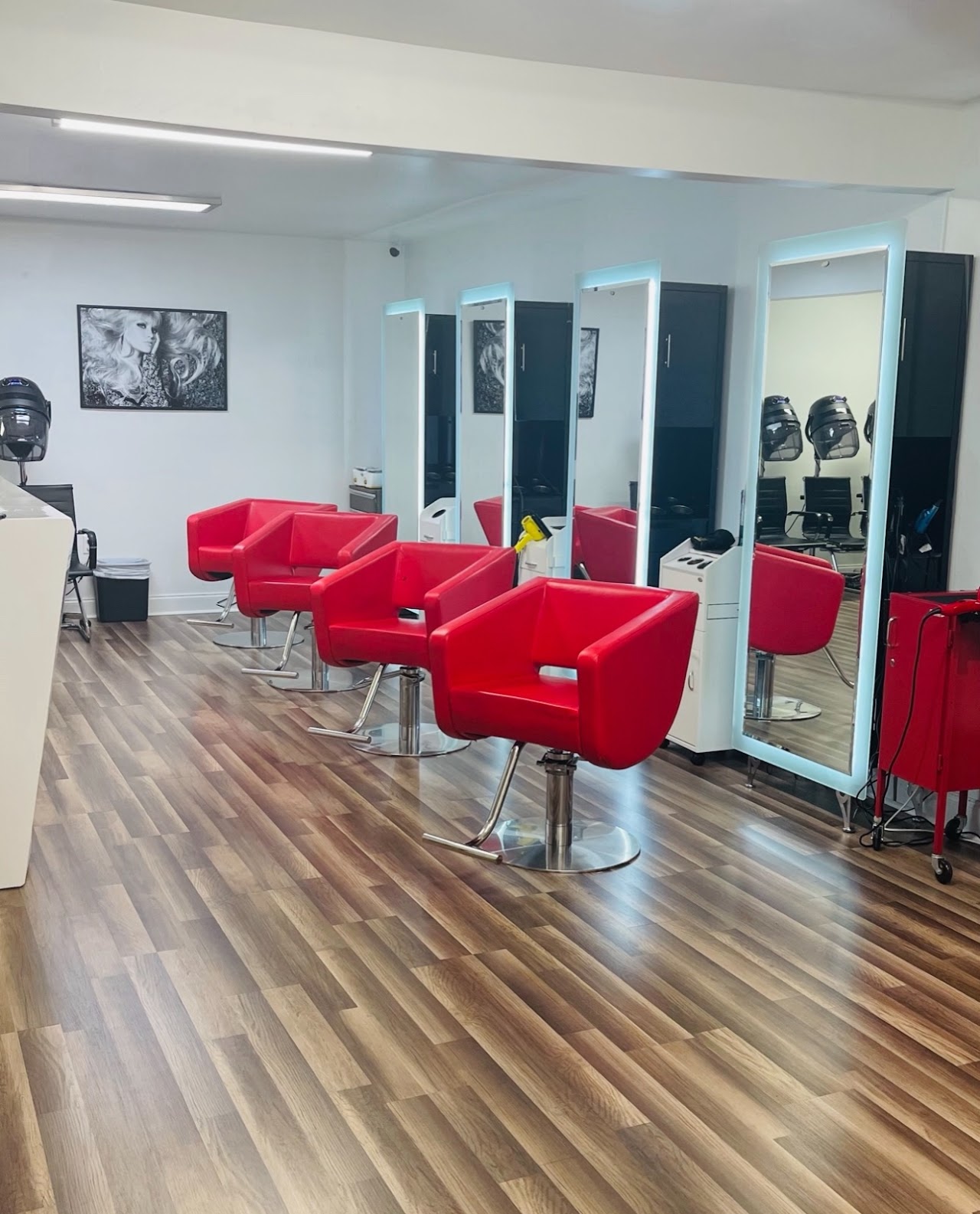 Hair Bar Experts salon interior with red styling chairs and lighted mirrors